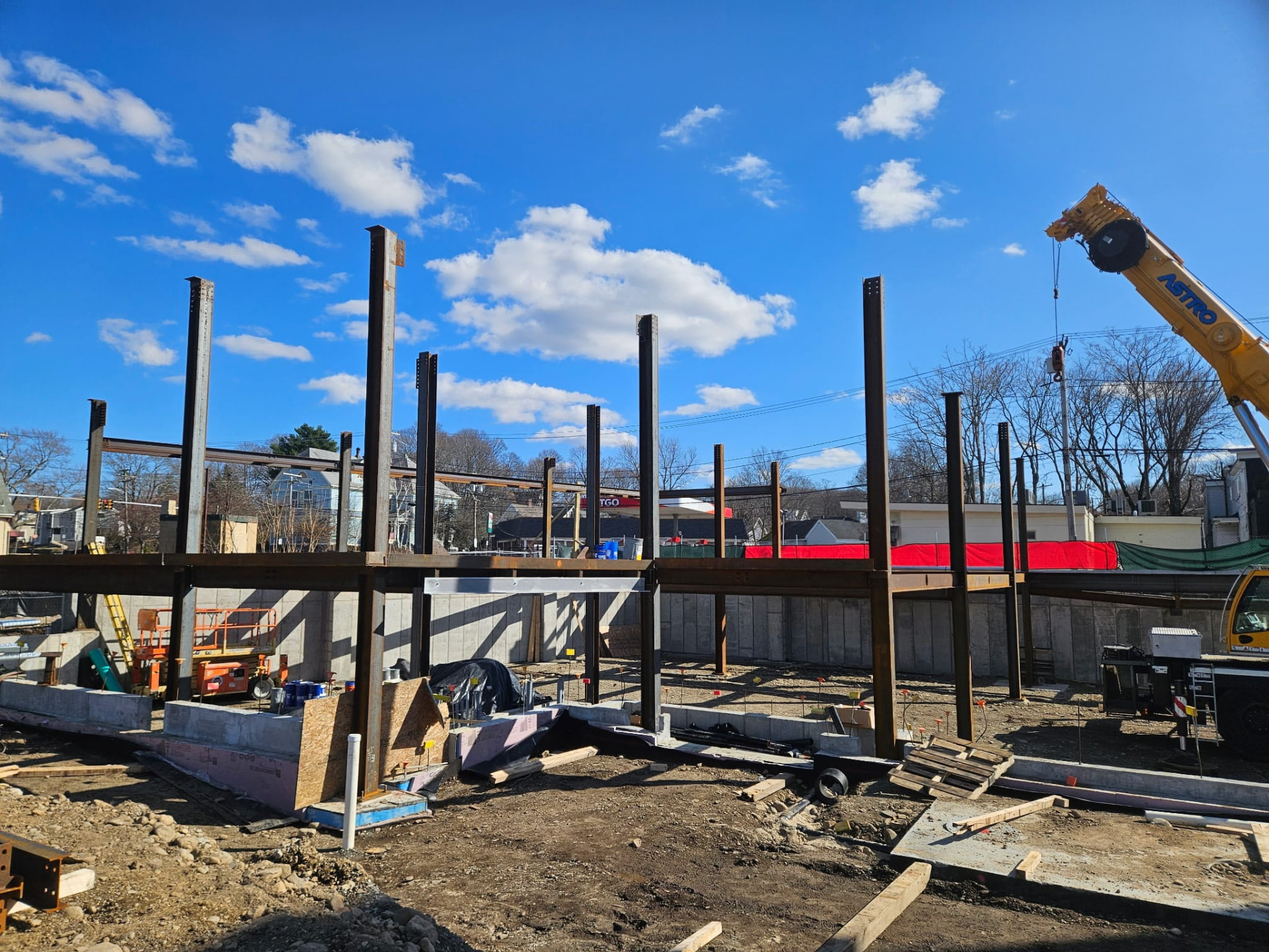 Steel columns and beams set on a concrete foundation wall