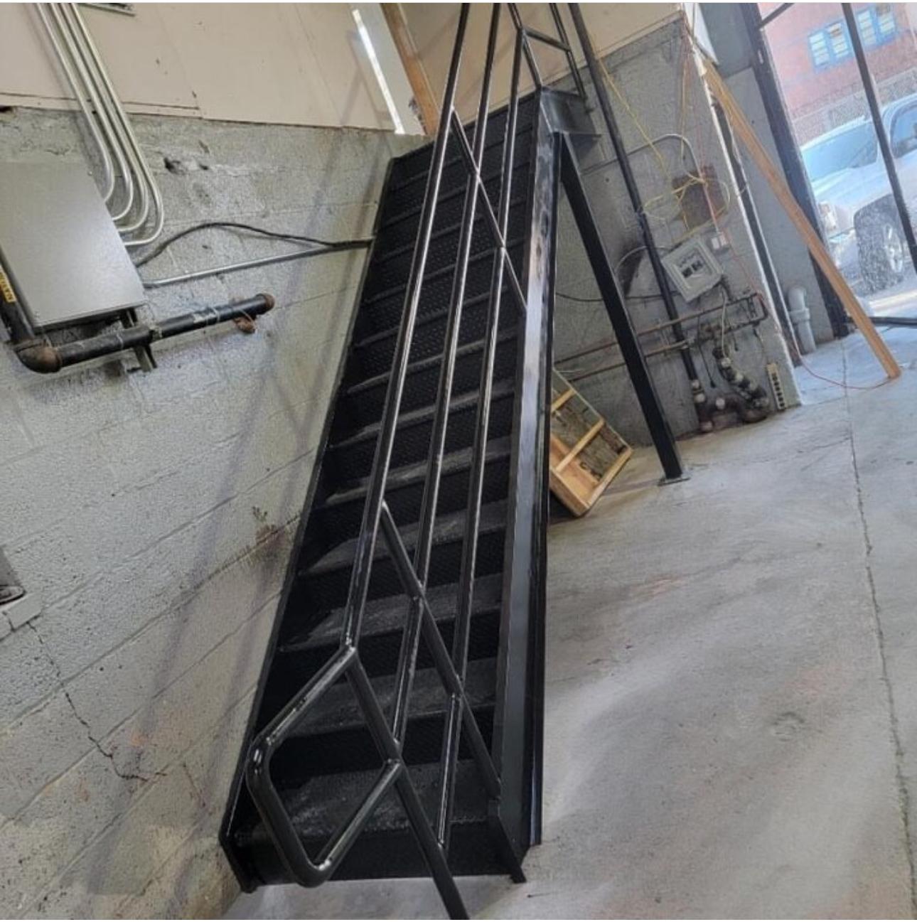 Industrial steel stair with diagonal bracing in a service corridor