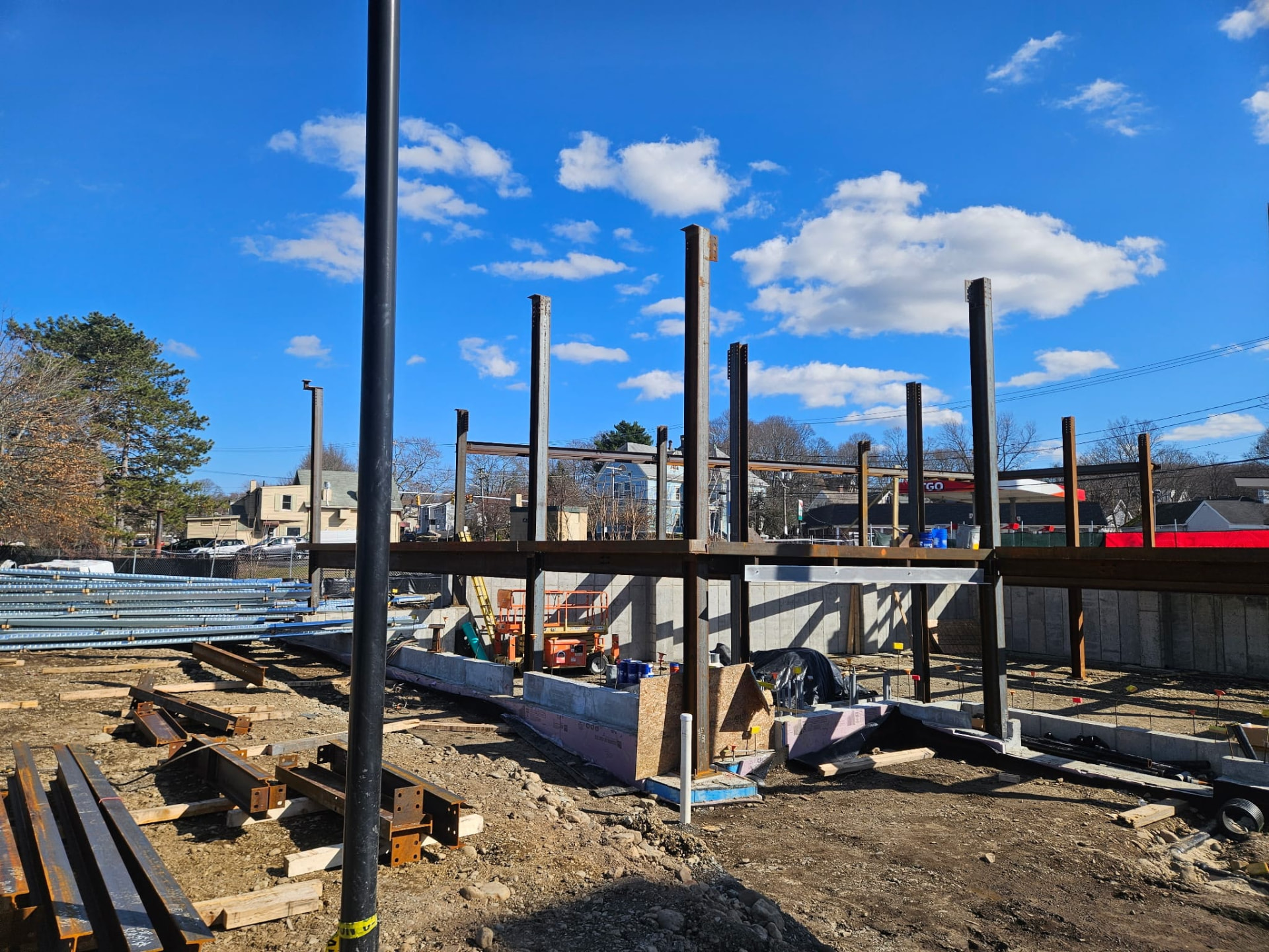 Steel column and beam frame over a concrete foundation on a clear day