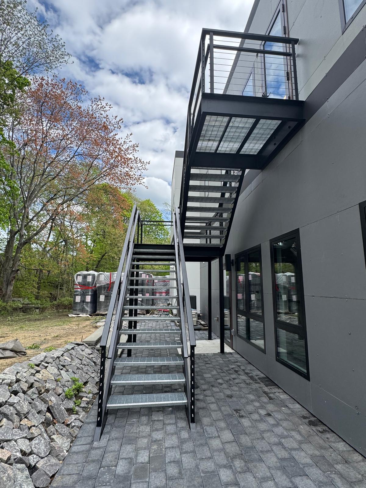 Modern exterior steel stair and landing with cable railing