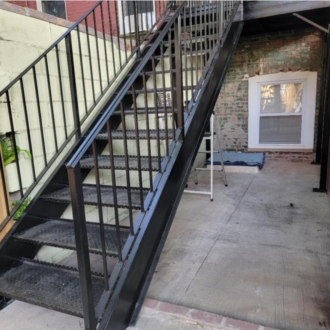 Black steel fire escape stair with diamond plate treads
