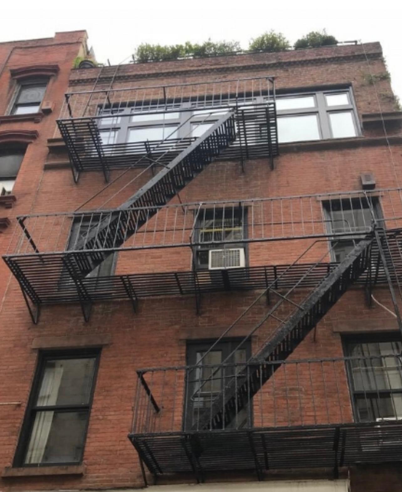 Steel fire escape stair system on a brick building facade
