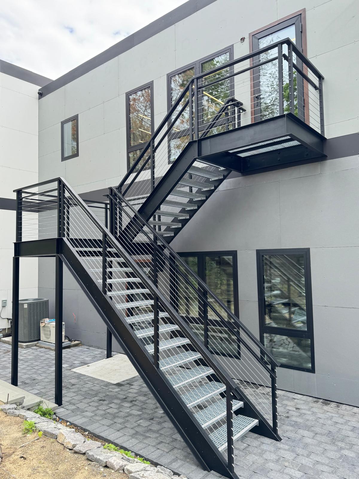 Modern steel stair with cable railing and intermediate landing
