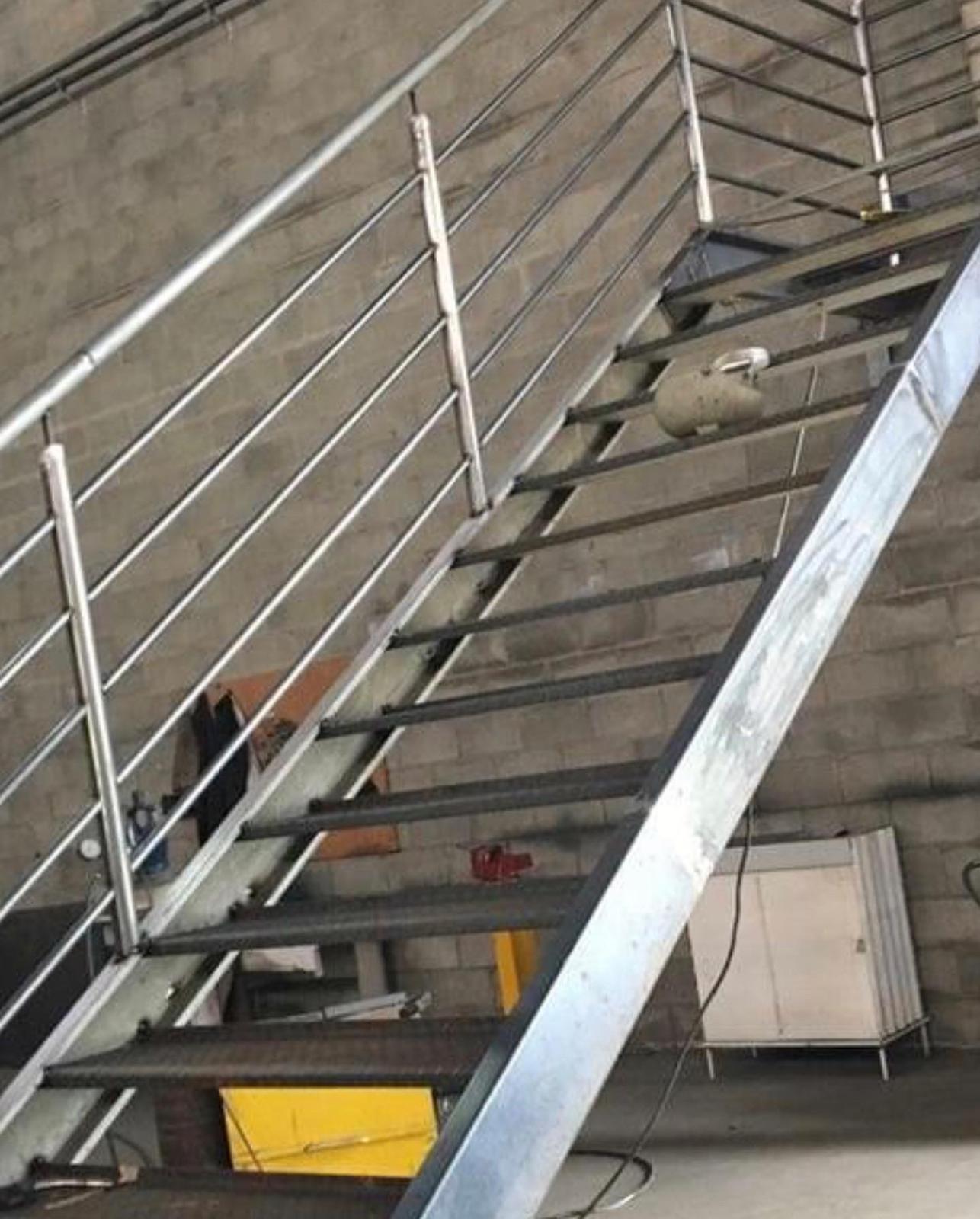 Steel stair installation inside a masonry building