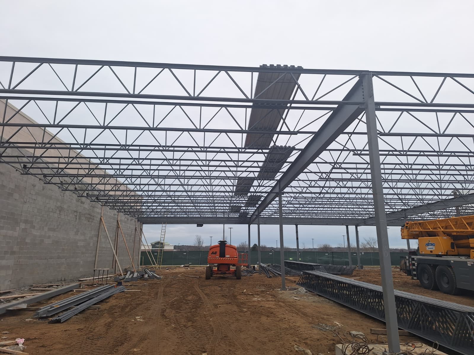 Structural steel frame with bar joists erected over a concrete block wall