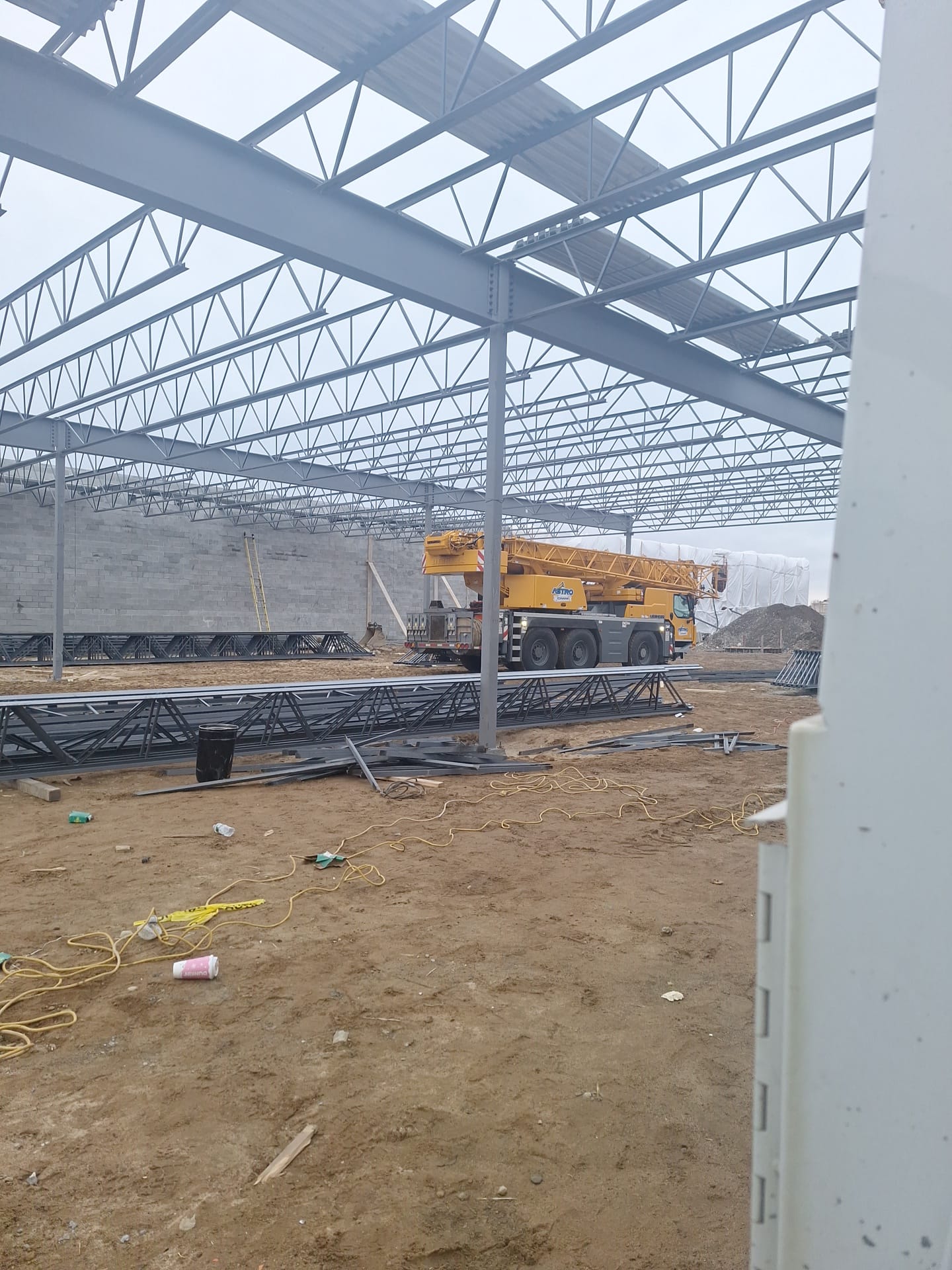 Interior view of a steel frame with joists and roof deck installed