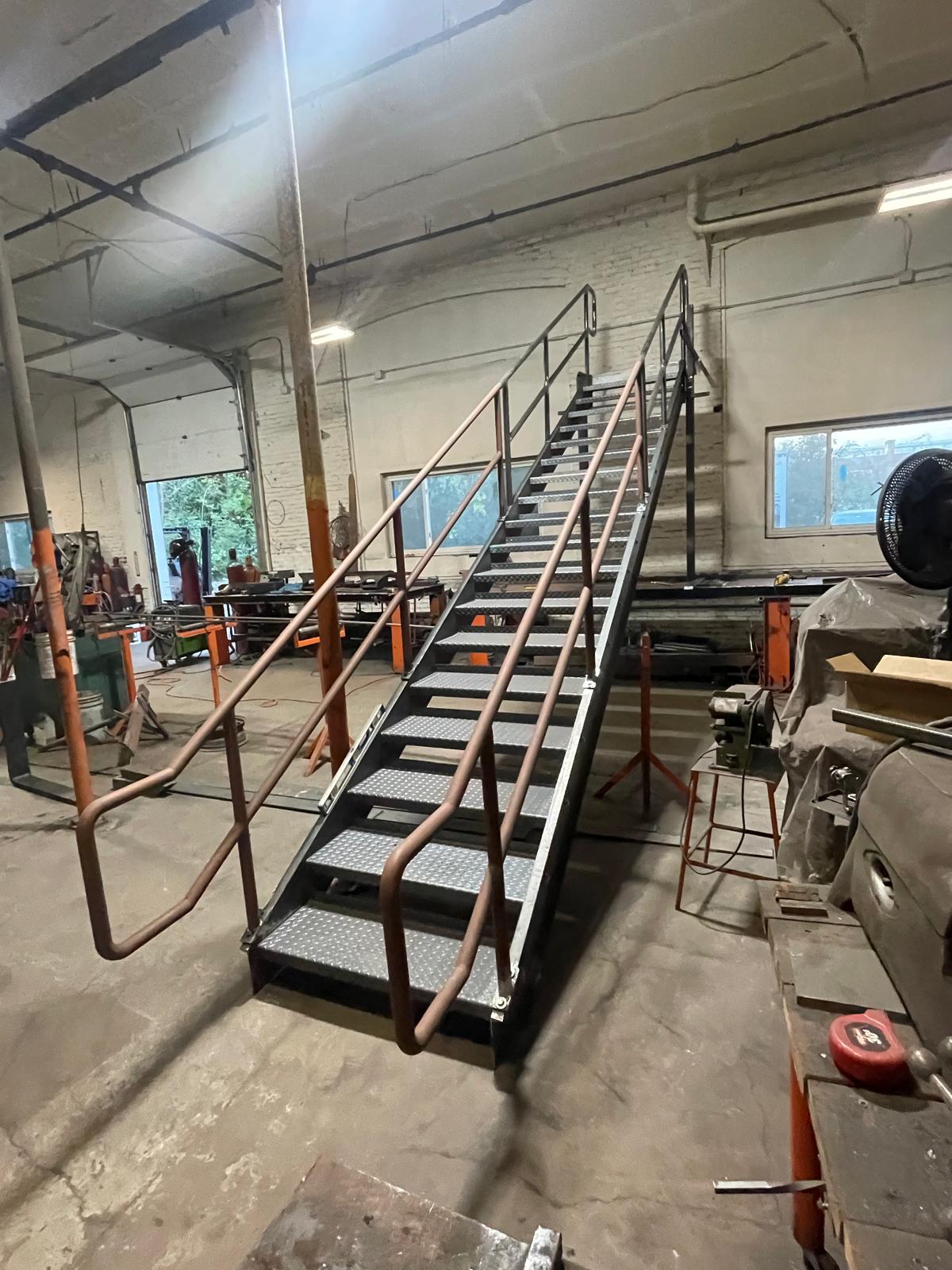 Fabricated steel stair with diamond plate treads in the shop